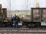 MOW workers watch as end of rail is pushed rearward